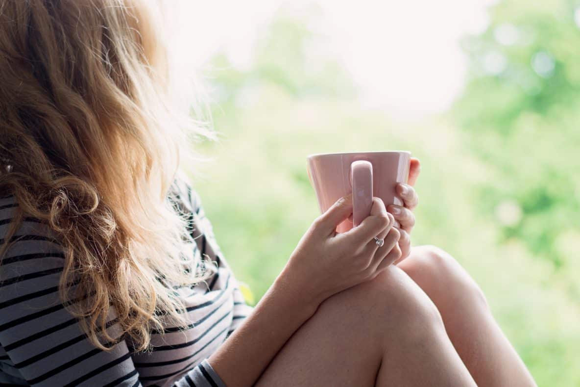 Woman holding cup of coffee relaxing