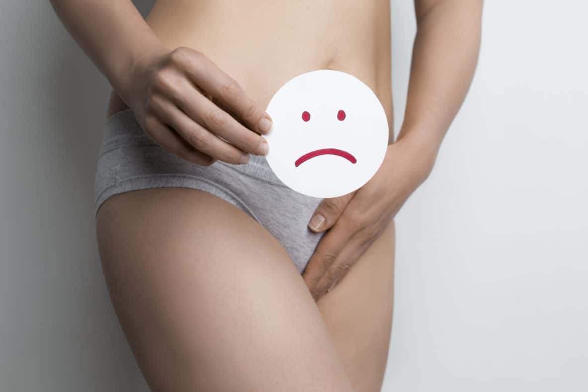 woman holding sad face next to her stomach
