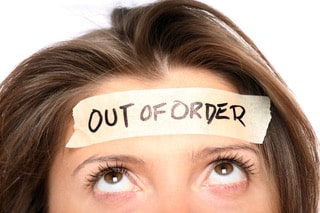 lady with out of order note on her forehead