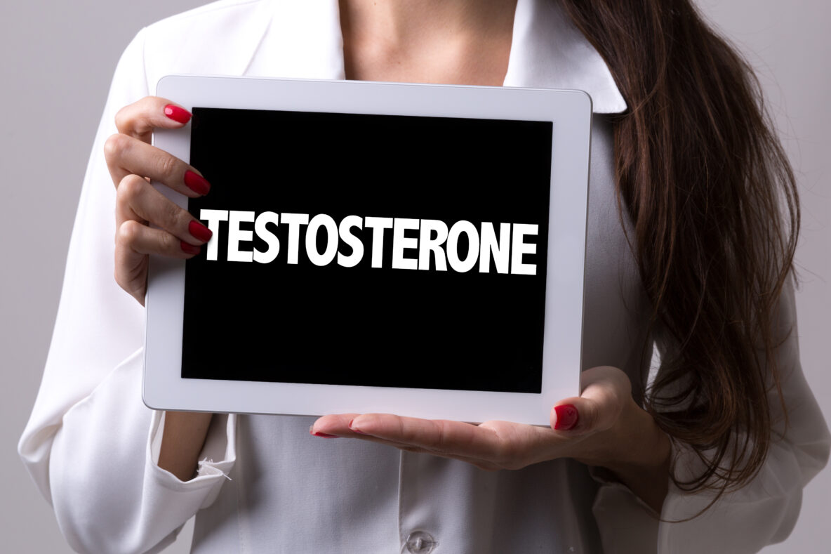 Female doctor holding up a sign saying 'testosterone'